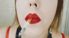 Cigarette Dangling And Smokes Close Up With Crimson Lips